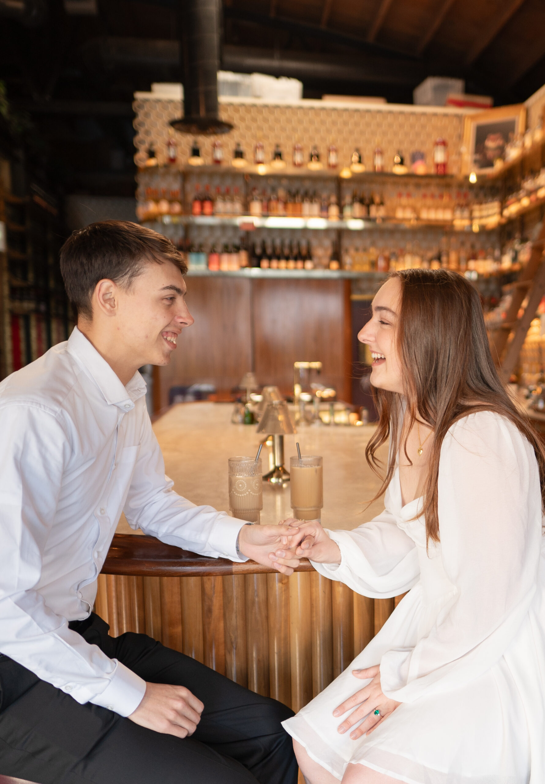 Couple in coffee shop for engagement session photos in San Diego