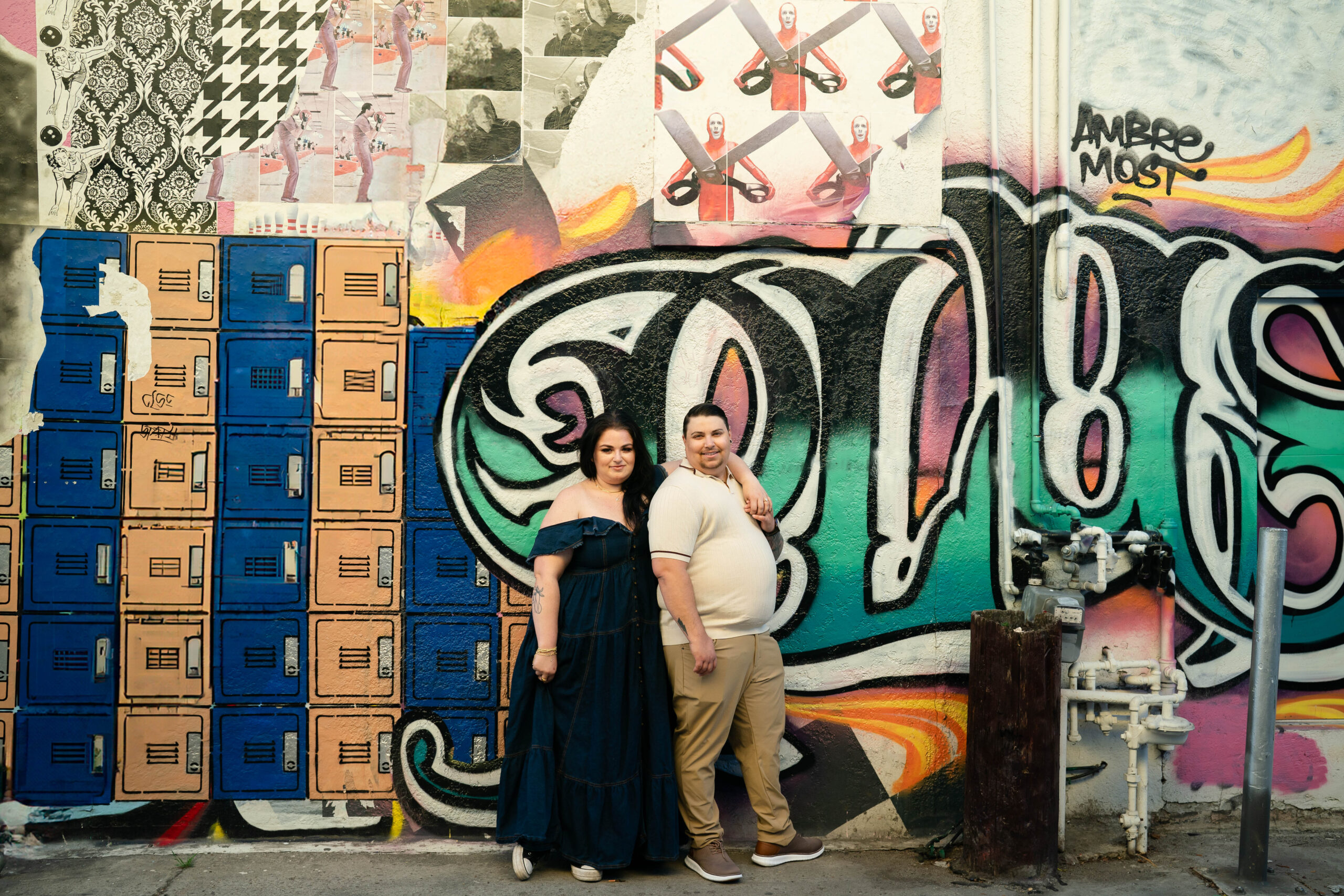 North Park mural with couple standing in front LGBTQ+ engagement session San Diego
