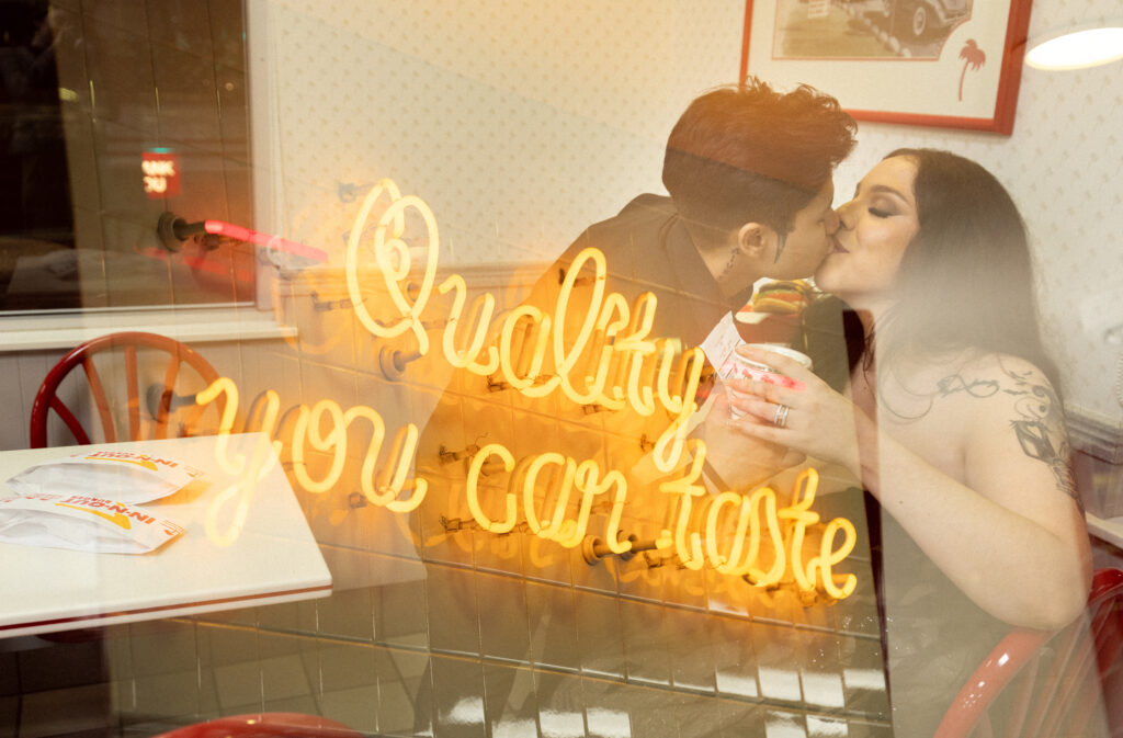 Bride and groom kiss after wedding at In-N-Out