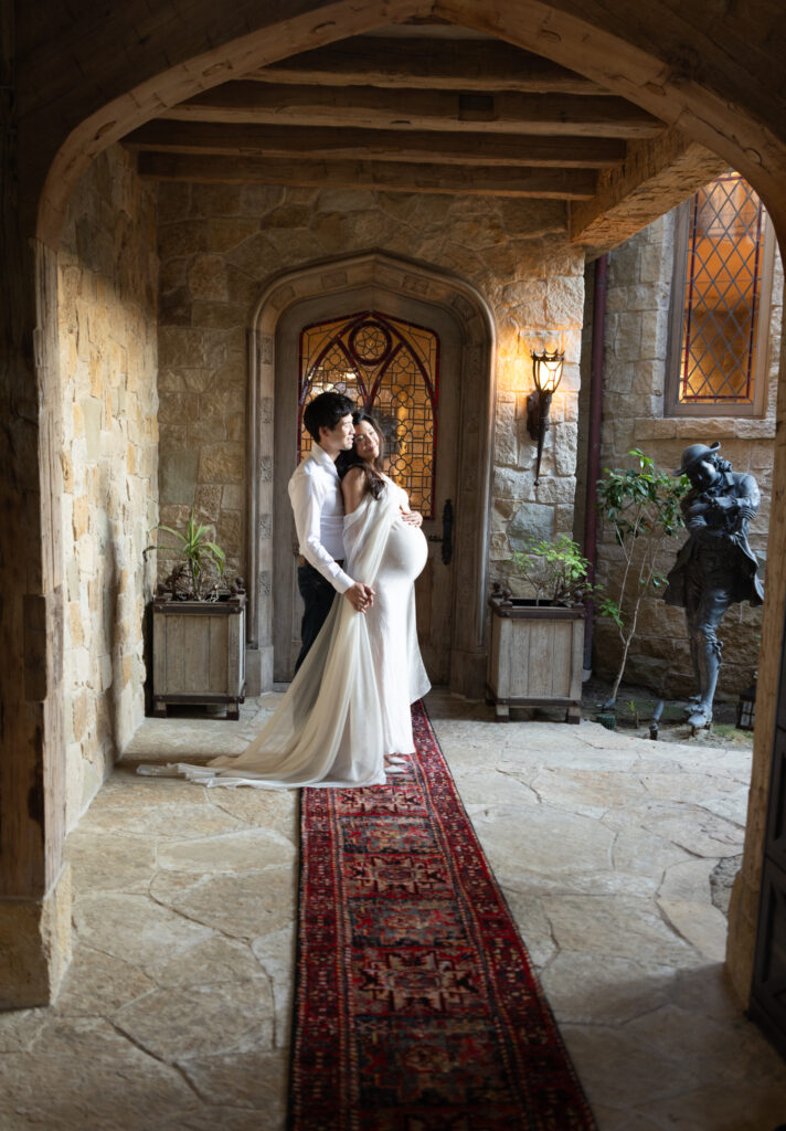 Couple leans into each other at home front porch for home maternity photos