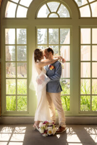 Botanic Garden Balboa Park sunlit window on elopement day with couple embracing 