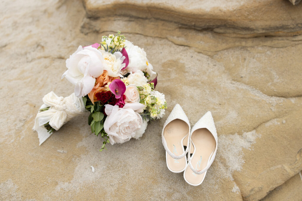 Wedding bouquet and shoes at Windansea Beach San Diego elopement