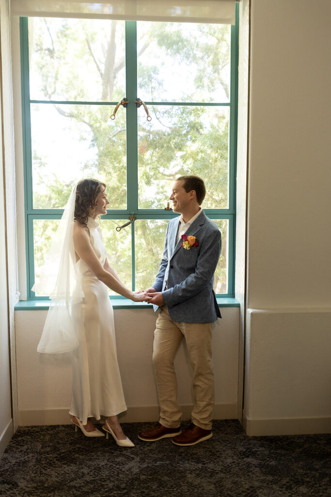 Couple look at each other while waiting for San Diego courthouse marriage office appointment