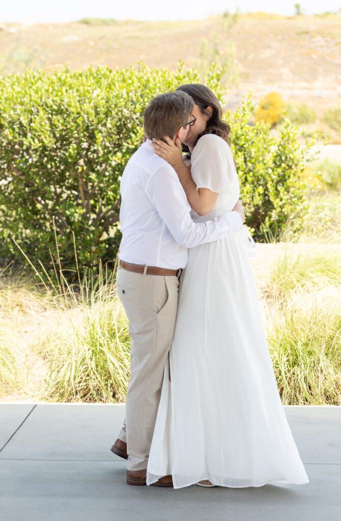 Two brides kiss at wedding ceremony at Santee San Diego courthouse wedding